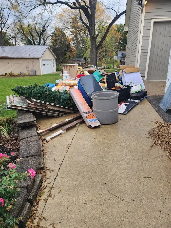 Dumpster being loaded with debris for 12 Yard Dumpster Rental in Okauchee Lake